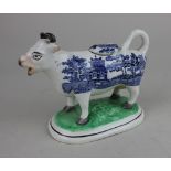 A Staffordshire pottery willow pattern cow creamer 12.5cm high
