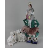 A Staffordshire flatback pottery figure of a hunter and lion 40cm, a pair of spaniels 14cm and a