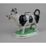 A Staffordshire pottery black and white cow creamer 12.5cm high