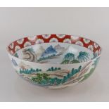 A Chinese porcelain rose bowl decorated with figures in a landscape, red character marks and