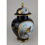 A Dresden porcelain ginger jar and cover decorated with opposing oval panels of winter garden