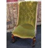 A Victorian carved frame green button upholstered chair on cabriole legs and castors