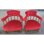 A pair of Victorian button upholstered chairs with raised bow backs on balustrade supports, fluted