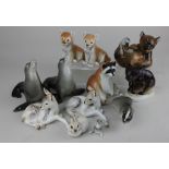A collection of Russian ceramic animal figures to include a Racoon, pair of seals, Badger, bears,