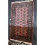 A yellow ground Turkoman type rug with central elephant foot motifs 104cm by 192cm and another