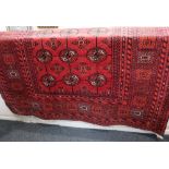 A Turkoman type rug crimson field with central rows of elephant foot motifs, 146cm by 198cm