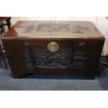 A Chinese carved camphorwood blanket chest with brass handle and lock, internal tray, 101cm