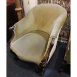 A Victorian green upholstered armchair with carved scroll arms and cabriole legs