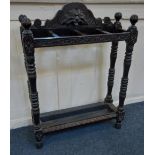 A carved oak stick stand four divisions with lion mask surmount, and metal tray inset base, 61cm