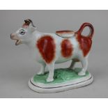 A Staffordshire pottery brown and white cow creamer 12cm high