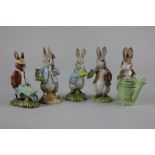 Four Beswick Beatrix Potter figures comprising Peter in the Watering Can, Peter Rabbit Gardening,
