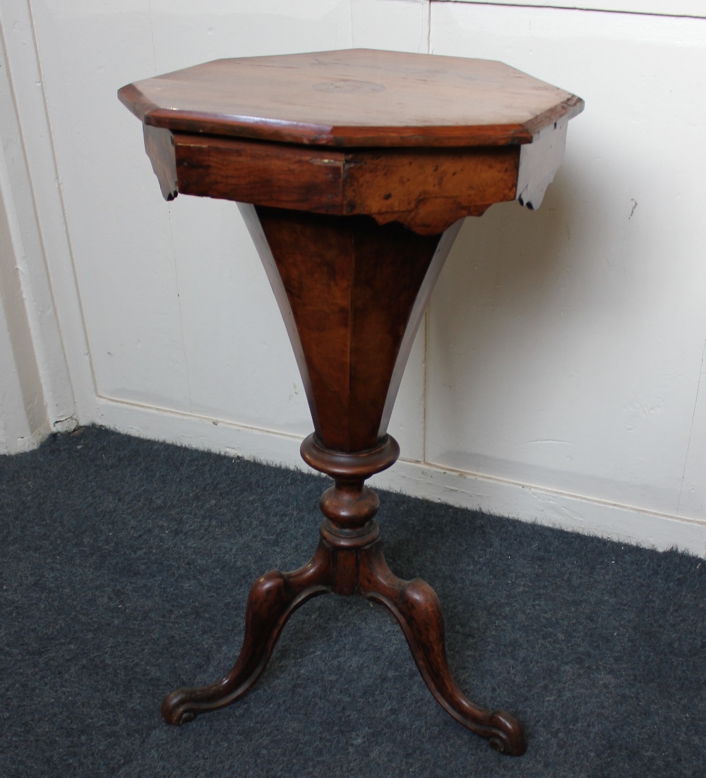 A Victorian inlaid walnut sewing table octagonal rising top enclosing fitted interior on tapered