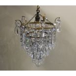 A gilt metal circular three tier chandelier light fitting with hanging glass droplets 21cm diameter,