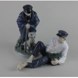 Two Royal Copenhagen porcelain figures of a boy with a dog and another of a reclining youth, 19cm