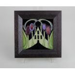 A framed Moorcroft pottery 'The Hamlet' pattern tile 11.5cm by 11.5cm