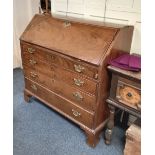 A George III mahogany bureau with fall enclosing fitted interior, four drawers, on bracket feet (a/
