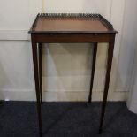 An Edwardian mahogany rectangular occasional table with three quarter brass gallery and slide, on