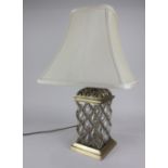 A gilt metal and glass table lamp with lattice design 30cm high