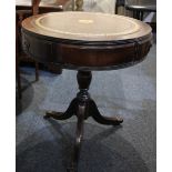 A reproduction small mahogany drum table brown leather inset top with three drawers, on tripod base,
