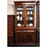 A Victorian mahogany bookcase two glazed door top with three shelves on base with drawer and two