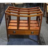 A mahogany three-division canterbury magazine rack with single drawer on tapered legs and castors,