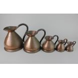 Five graduated copper jugs (one matched), largest 21cm high