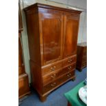 A George III mahogany linen press cupboard dentil carved cornice and two panelled doors enclosing