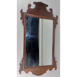 A George III style mahogany fret cut wall mirror 68cm by 38cm including frame