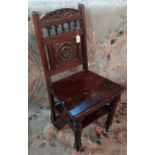 A Victorian metamorphic chair library steps with carved roundel panel back on turned front legs (a/