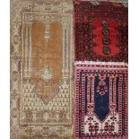 A small bokhara rug, red ground, with central row of four guls 68cm by 52cm, together with two