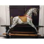 A grey dappled rocking horse with horse hair mane and tail, on wood and metal frame 110cm high (a/