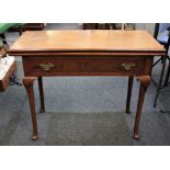 A George III mahogany rectangular tea table with fold over top, on four carved capped tapered legs