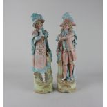 A pair of bisque porcelain figures of a lady and gentleman, with gilt embellishments, 34cm high