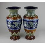 A pair of Royal Doulton glazed stoneware vases, of baluster form, with floral and foliate decoration