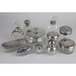 A collection of eleven various silver topped glass scent and dressing table bottles