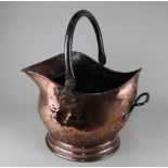 A copper coal scuttle 44cm high with handle raised