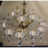 A gilt metal and cut glass twelve branch chandelier light fitting with hanging glass droplets approx