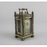 A miniature brass carriage clock with engraved dial, 10cm