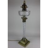 A Victorian cut glass column oil lamp converted to a table lamp 75cm high