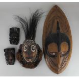 Tribal / ethnographic interest, five masks, by repute from Papua New Guinea, some set with cowrie