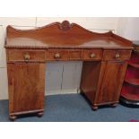 A George IV mahogany sideboard with three quarter gallery on inverted breakfront top with four