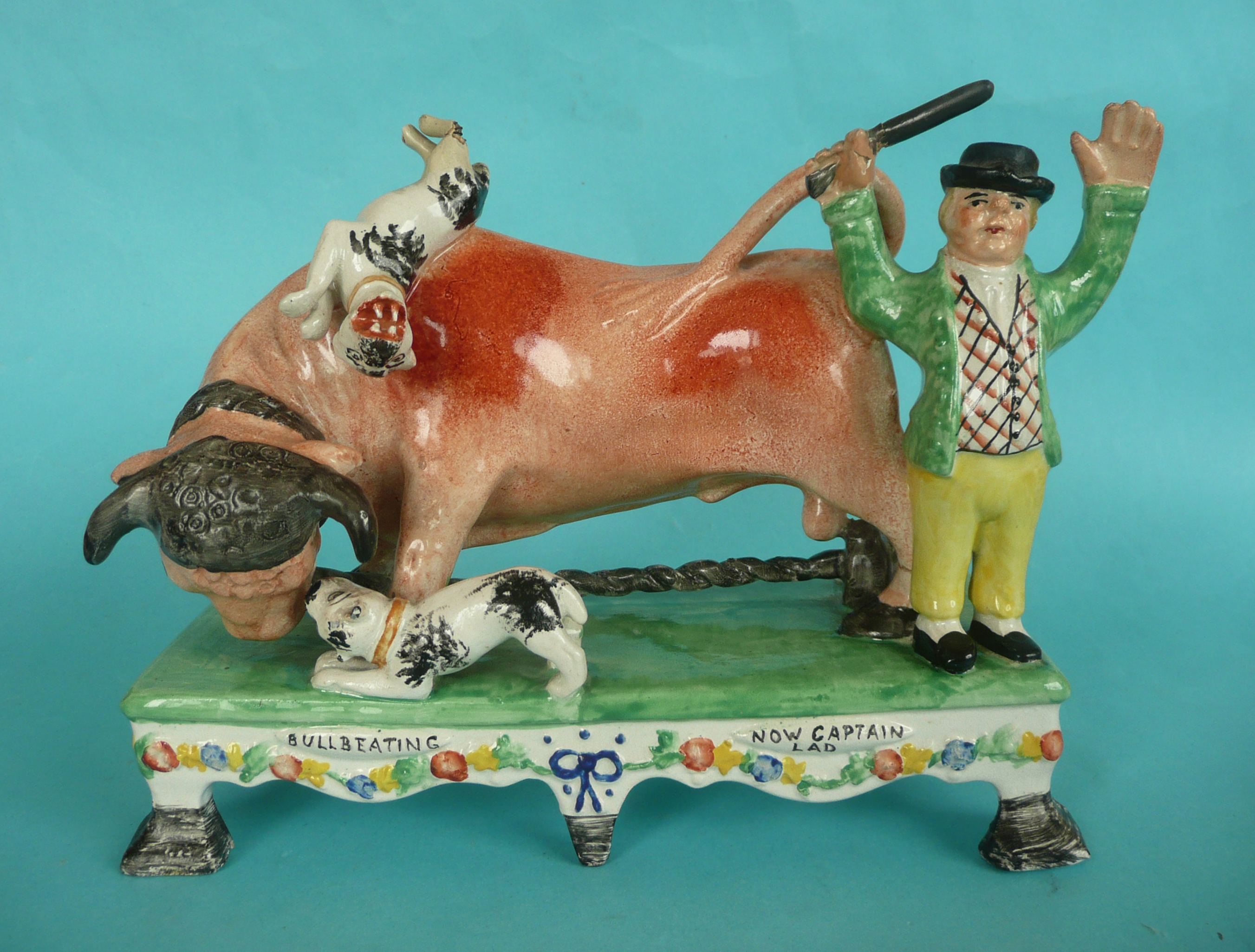 Bull Bating: a colourful Staffordshire pottery group in the manner of Obadiah Sherrat modelled