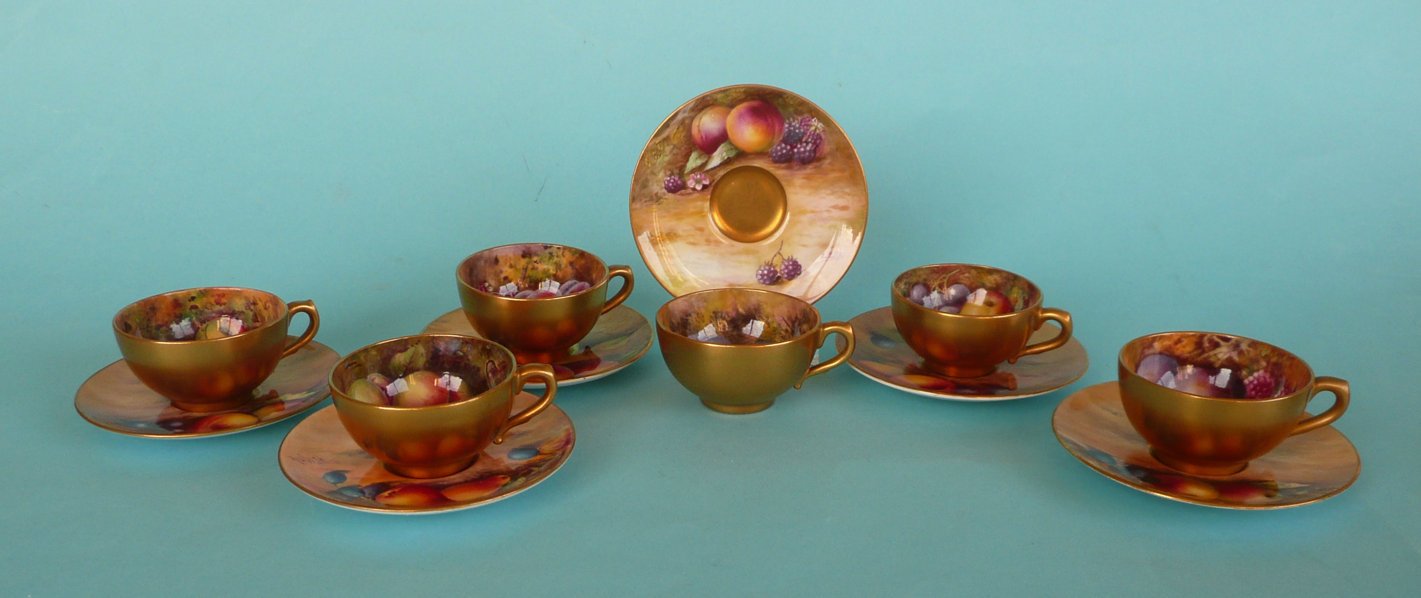 A good Royal Worcester miniature tea set comprising six cups and saucers each well painted