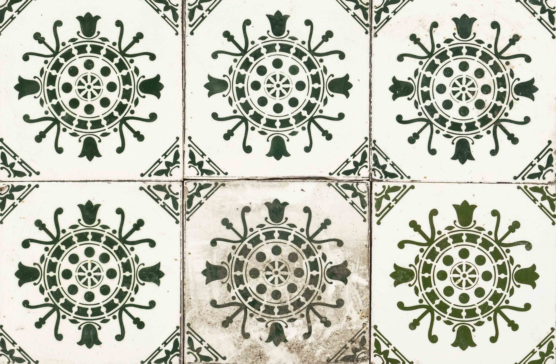 54 Art deco tiles, 1930s. Stenciled and sprayed decoration in dark green with stylized tulips, edges