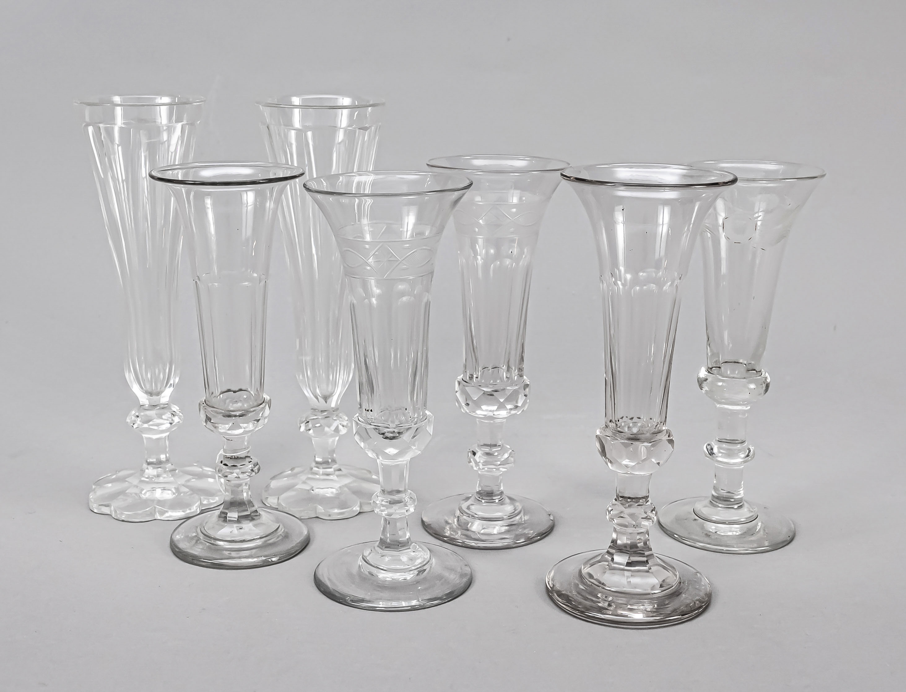 Set of seven champagne flutes, 19th/20th century, different shapes and sizes, each clear glass