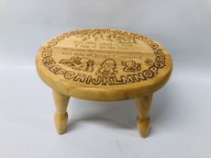 A CHILD'S BEECH WOOD STOOL CARVED WITH ALPHABET,