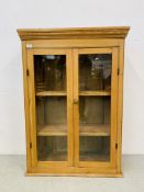 AN ANTIQUE WAXED PINE TWO DOOR GLAZED CABINET WITH SHELVED INTERIOR - W 78CM. D 30CM.H 112CM.