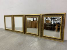 FOUR MATCHING ORNATE GILT FRAMED BEVELLED WALL MIRRORS EACH W 55CM. H 66CM.