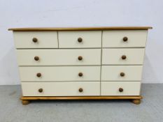 A MODERN PINE AND CREAM FINISH MULTI DRAWER CHEST - W 121CM. D 39CM. H 75CM.