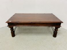 A RUSTIC HARDWOOD COFFEE TABLE WITH IRONCRAFT DETAIL - W 110CM. D 60CM. H 41CM.